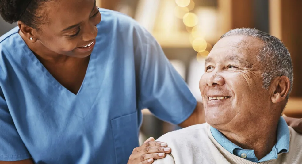 Caregiver speaking with an older adult, imagery used in the Select Hospice website