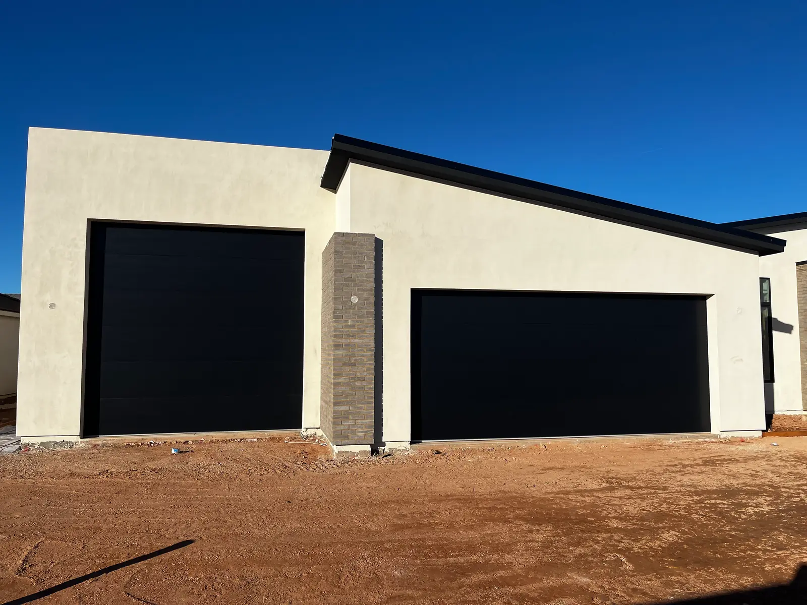 Completed matte black sectional garage-door installation by STG Garage Co.