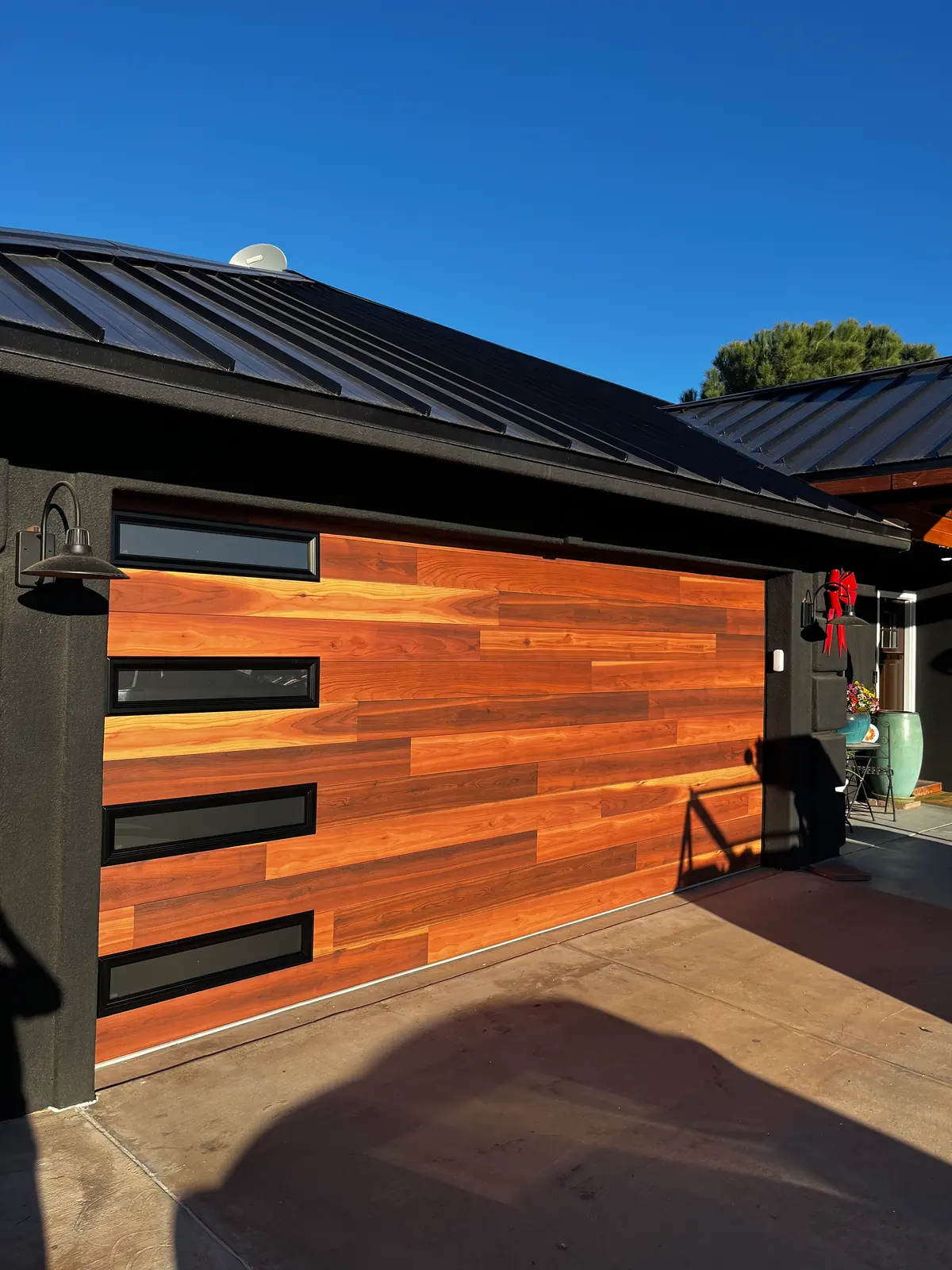 Completed modern wood-grain garage-door installation by STG Garage Co.